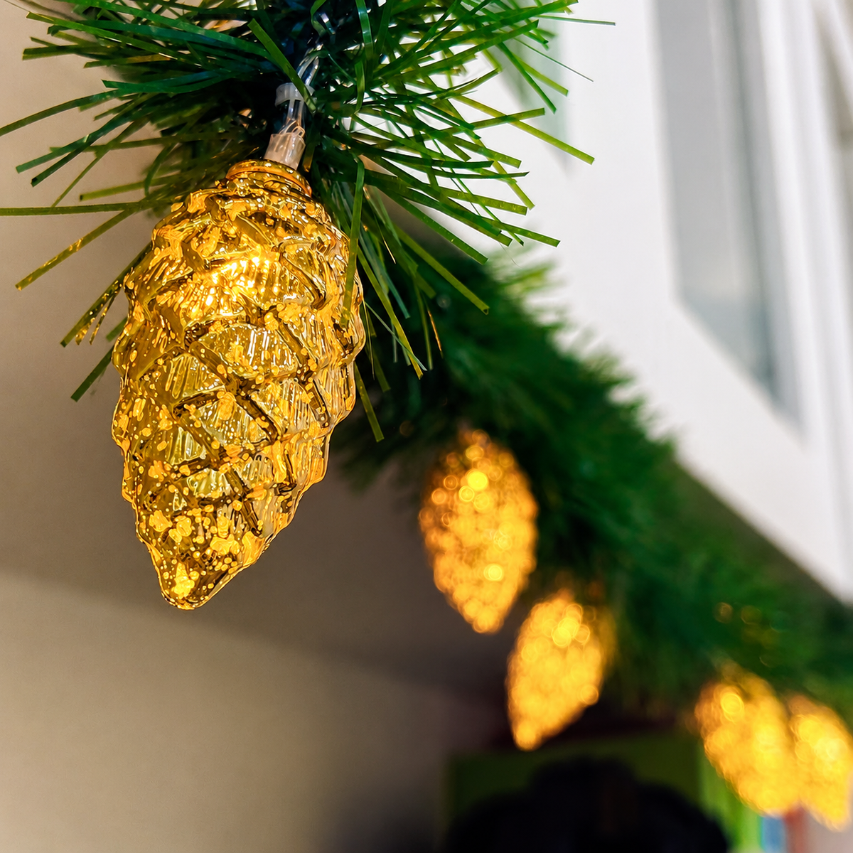 Pinecone garland lights warm gold detail